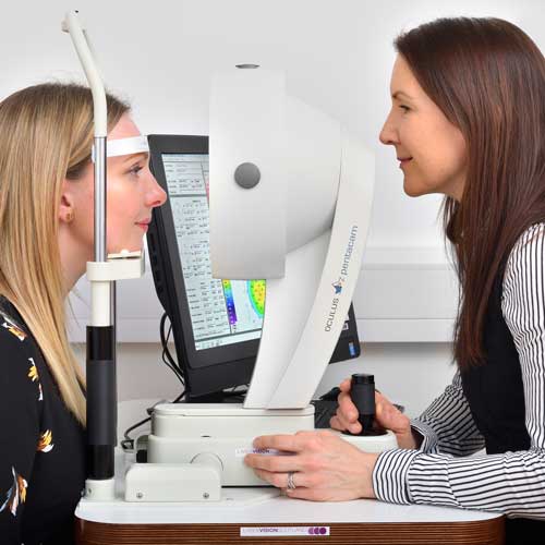 Catriona with a patient carrying out diagnostic tests for lens replacement surgery