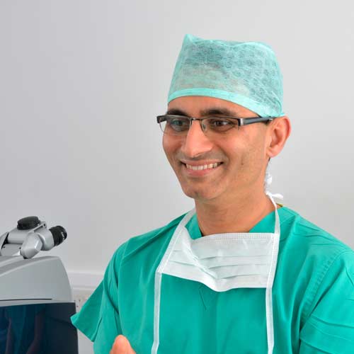Mr Sanjay Mantry, Consultant Ophthalmic surgeon in scrubs