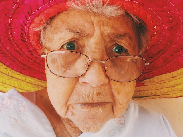 elderly lady with glasses thinking about cataract surgery